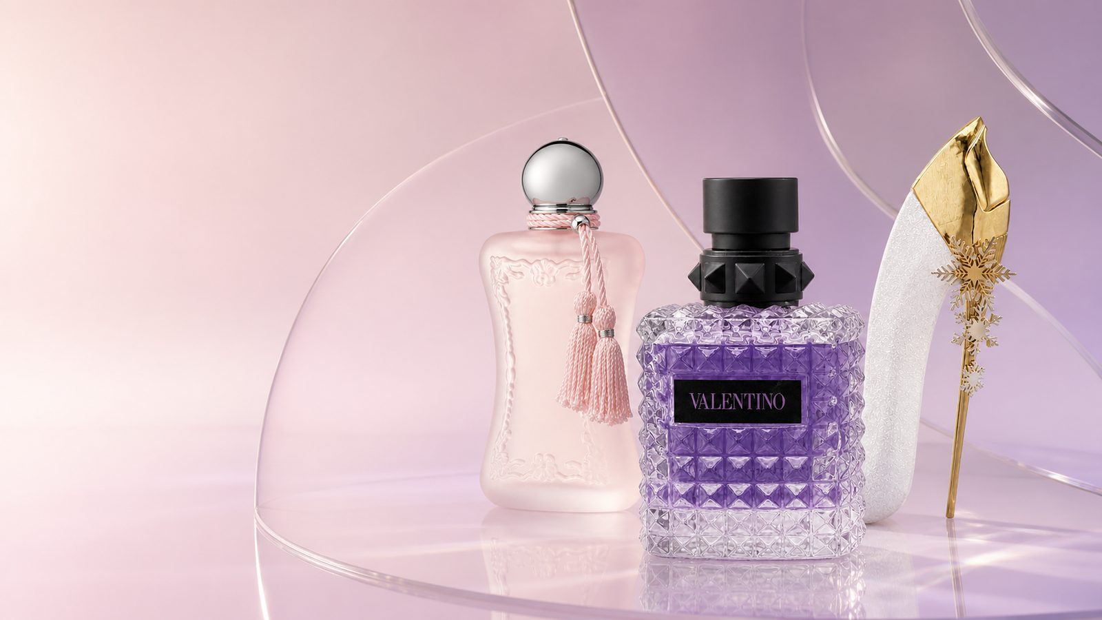 Several bottles from a fragrance collection on a pale surface.